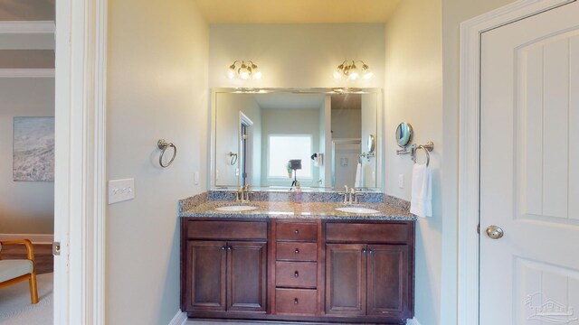 265 Tropical Breeze Dr, Santa Rosa Beach, FL 32459 - bathroom featuring baseboards, double vanity, and a sink