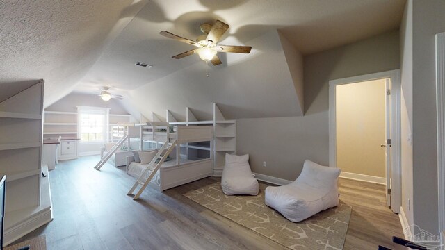 265 Tropical Breeze Dr, Santa Rosa Beach, FL 32459 - bedroom featuring wood finished floors, a textured ceiling, vaulted ceiling, and visible vents