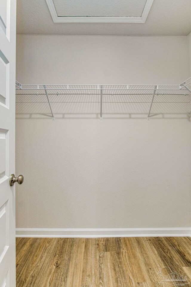 6329 Firefly Dr, Milton, FL 32583 - spacious closet with attic access and wood finished floors