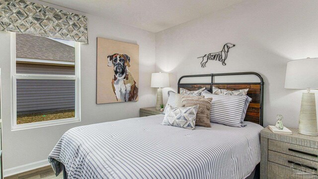 6329 Firefly Dr, Milton, FL 32583 - bedroom featuring wood finished floors and baseboards