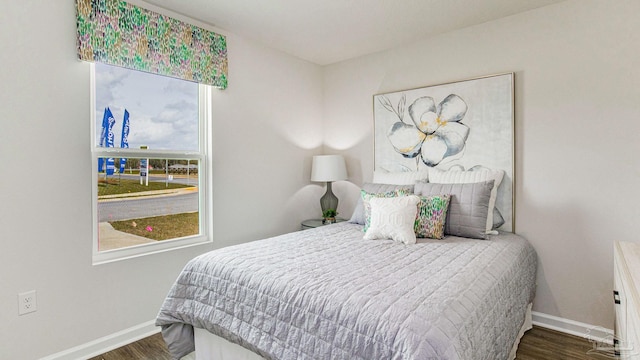 bedroom featuring wood finished floors and baseboards