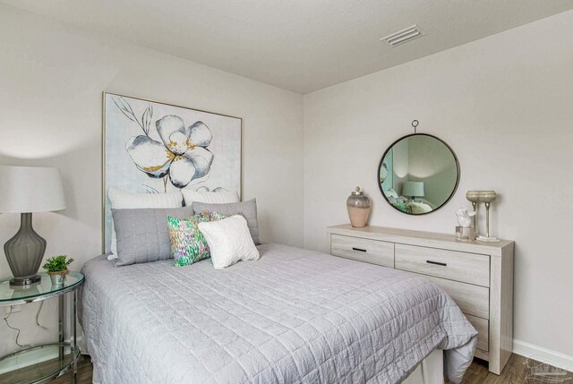 6329 Firefly Dr, Milton, FL 32583 - bedroom with wood finished floors and visible vents
