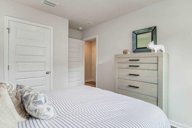 bedroom featuring visible vents and baseboards