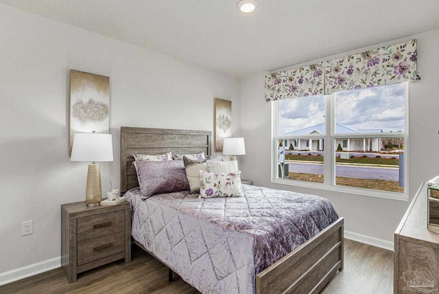 bedroom with wood finished floors and baseboards