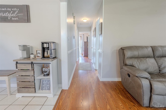 corridor with light hardwood / wood-style flooring