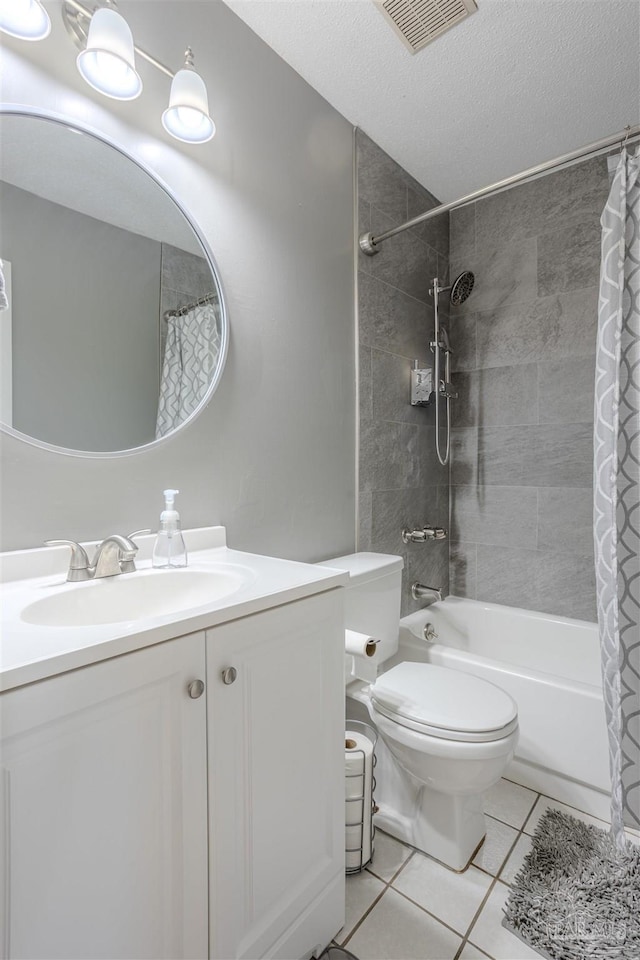 full bathroom featuring shower / tub combo with curtain, tile patterned flooring, vanity, toilet, and a textured ceiling