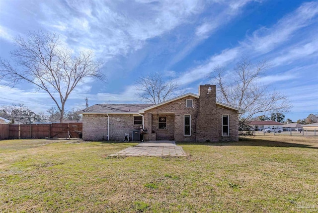 rear view of property featuring a yard, a patio area, and central air condition unit