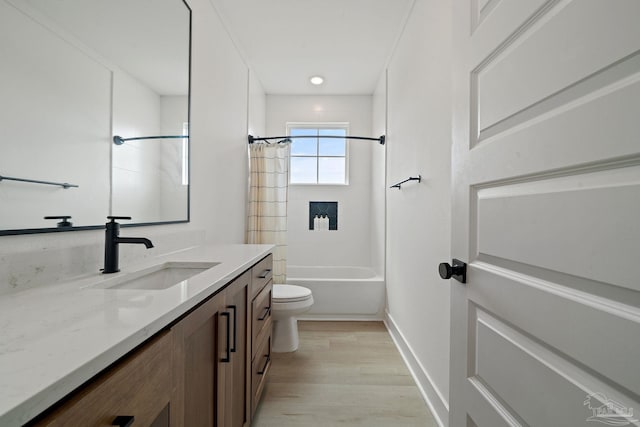 full bath featuring shower / tub combo with curtain, toilet, vanity, wood finished floors, and baseboards