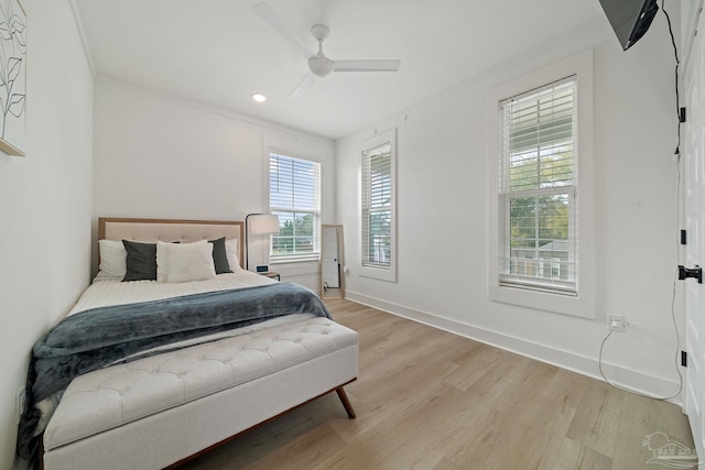 bedroom with baseboards, ceiling fan, and light wood-style floors