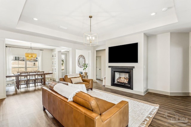 1058 Iron Forge Rd, Cantonment, FL 32533 - living room featuring a chandelier, a tray ceiling, wood finished floors, and recessed lighting