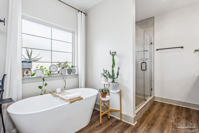 1058 Iron Forge Rd, Cantonment, FL 32533 - full bath with a stall shower, wood finished floors, a soaking tub, and baseboards