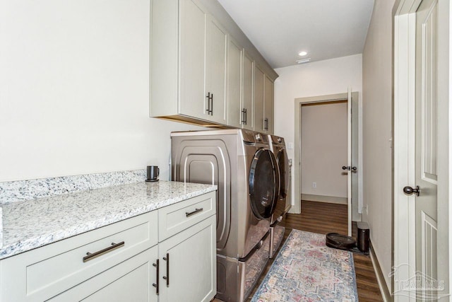 1058 Iron Forge Rd, Cantonment, FL 32533 - washroom featuring separate washer and dryer, cabinet space, dark wood-style floors, and recessed lighting