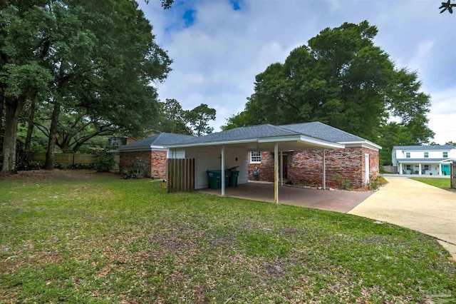 316 Dolphin St, Gulf Breeze, FL 32561 - rear view of house with driveway and a carport