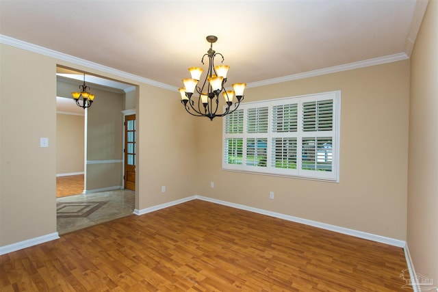 316 Dolphin St, Gulf Breeze, FL 32561 - spare room featuring a chandelier, crown molding, wood finished floors, and baseboards