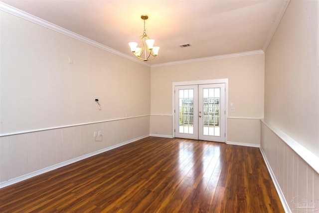 316 Dolphin St, Gulf Breeze, FL 32561 - unfurnished room with a chandelier, hardwood / wood-style flooring, crown molding, a wainscoted wall, and french doors