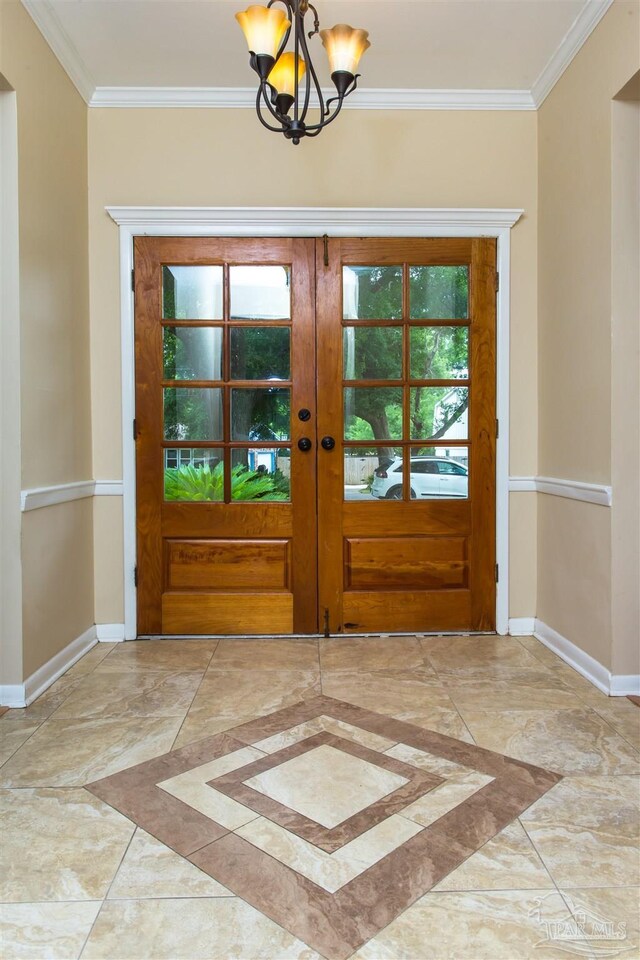 316 Dolphin St, Gulf Breeze, FL 32561 - entrance foyer with inlaid floor details, a chandelier, baseboards, and crown molding