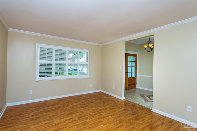 316 Dolphin St, Gulf Breeze, FL 32561 - unfurnished room featuring light wood-type flooring, a chandelier, ornamental molding, and baseboards