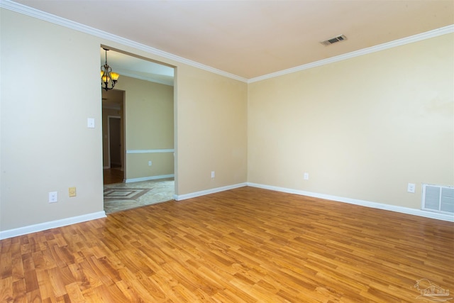 316 Dolphin St, Gulf Breeze, FL 32561 - empty room with light wood-style floors, crown molding, a chandelier, and baseboards