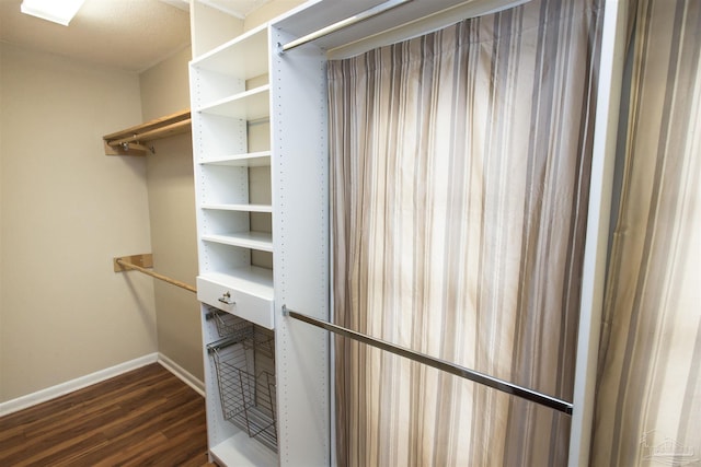 316 Dolphin St, Gulf Breeze, FL 32561 - walk in closet with dark wood-style flooring