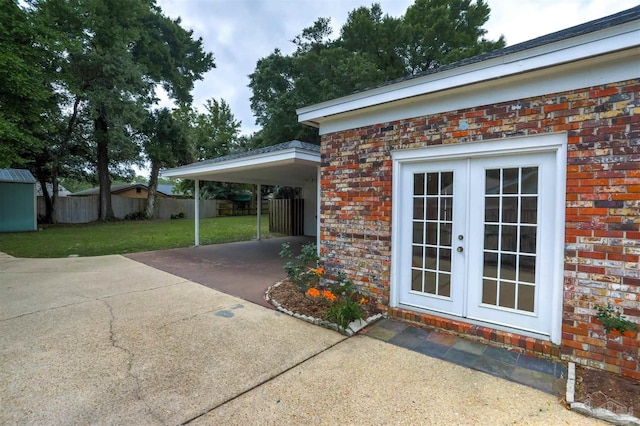 316 Dolphin St, Gulf Breeze, FL 32561 - view of patio with french doors, driveway, and a carport