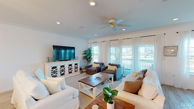 living room featuring ceiling fan, light hardwood / wood-style flooring, and crown molding