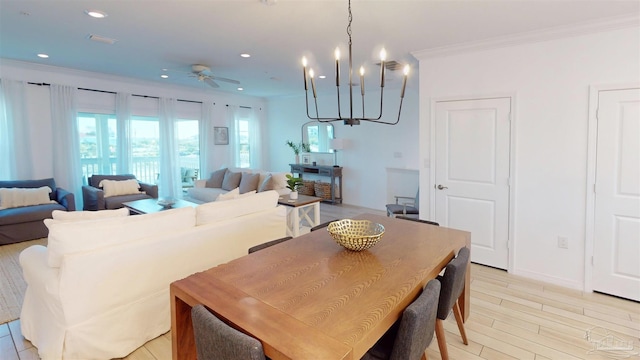 dining room featuring ceiling fan with notable chandelier, crown molding, and light hardwood / wood-style flooring