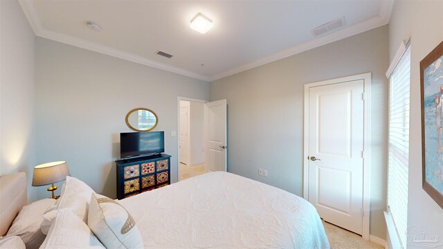 bedroom with light carpet and ornamental molding