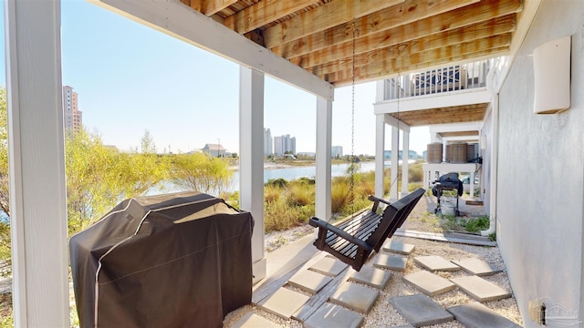 view of patio / terrace with a water view and a grill