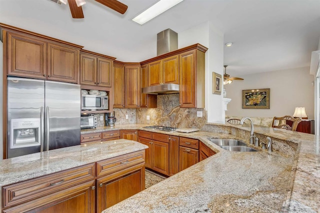 kitchen featuring ceiling fan, backsplash, light stone countertops, sink, and stainless steel appliances