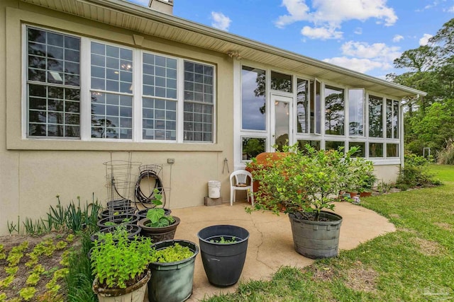 view of patio with a sunroom