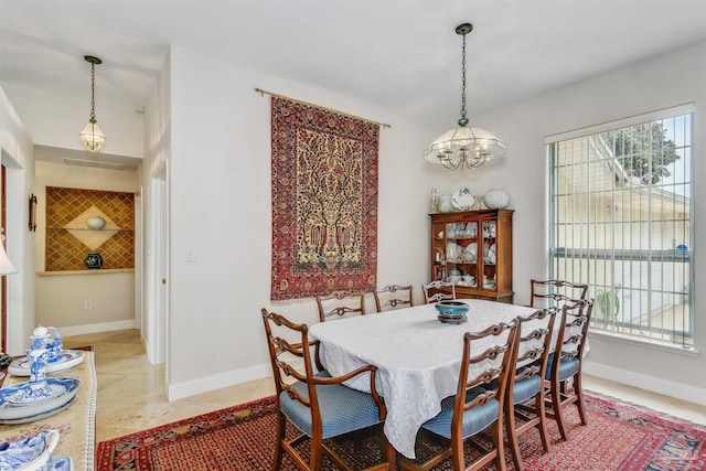 dining area with an inviting chandelier