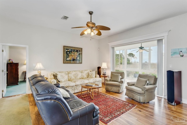 living room with hardwood / wood-style floors and ceiling fan