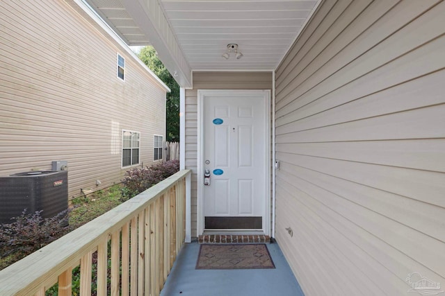 view of exterior entry with central air condition unit