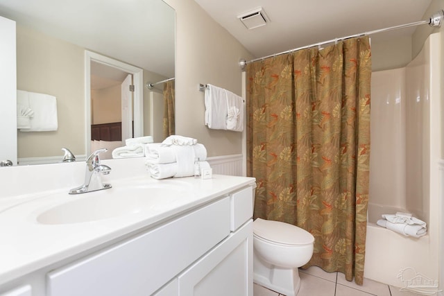 bathroom featuring visible vents, toilet, shower / bathtub combination with curtain, vanity, and tile patterned flooring