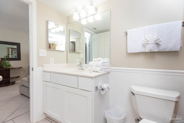 bathroom featuring tile patterned floors, vanity, visible vents, and toilet