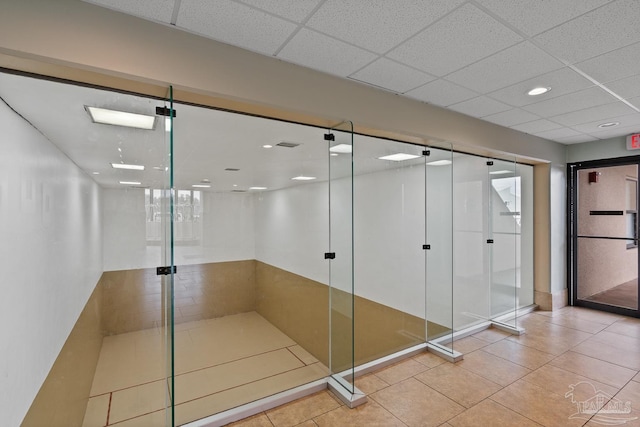 bathroom featuring recessed lighting, a paneled ceiling, tile patterned flooring, and a shower with shower door