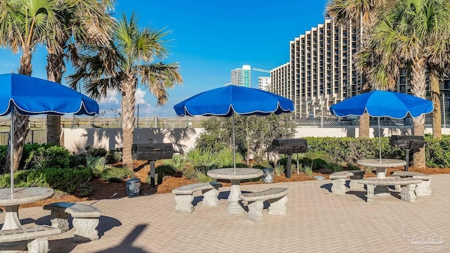 surrounding community with a patio area and fence