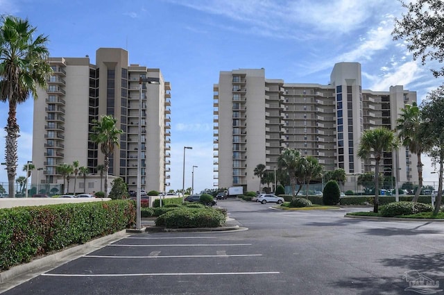 view of building exterior with uncovered parking