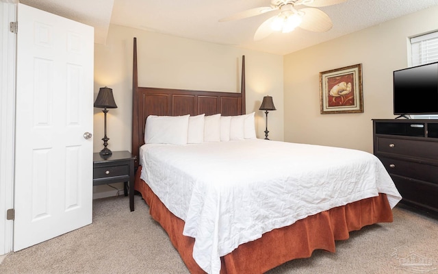bedroom featuring a ceiling fan and light colored carpet
