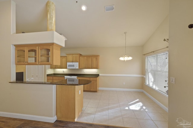 kitchen with kitchen peninsula, light tile patterned flooring, decorative light fixtures, and a notable chandelier