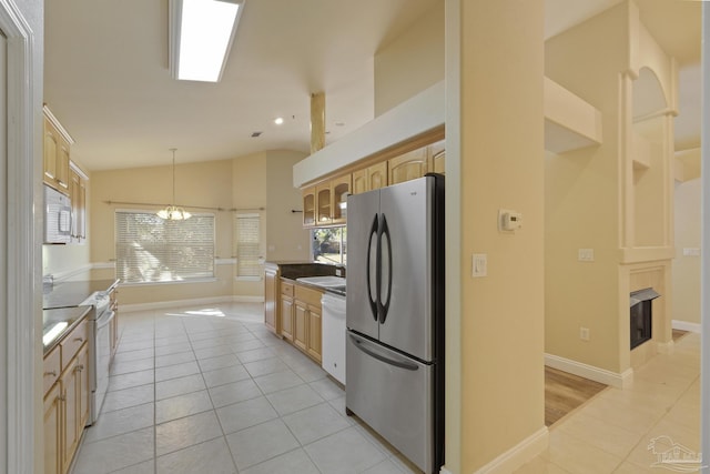 kitchen featuring light tile patterned flooring, white appliances, hanging light fixtures, and vaulted ceiling