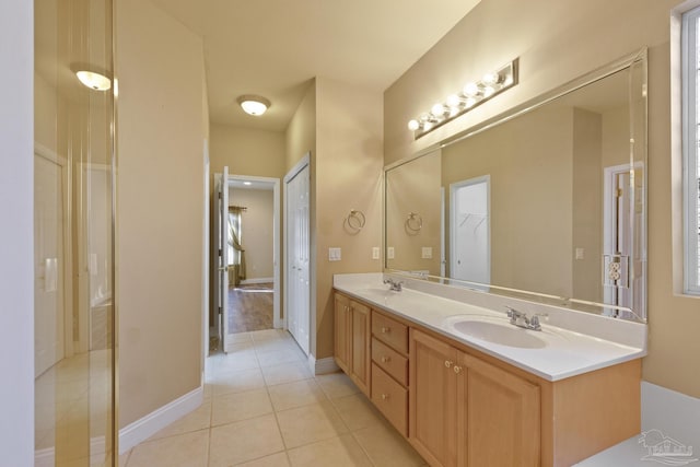 bathroom featuring tile patterned flooring and vanity