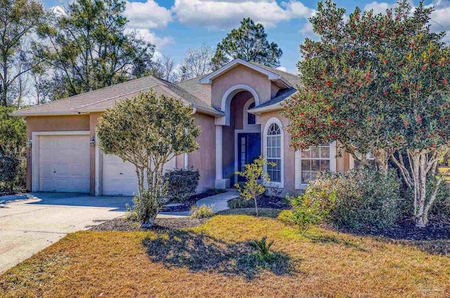 ranch-style home featuring a garage and a front lawn