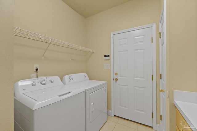 laundry area with light tile patterned floors and washing machine and dryer