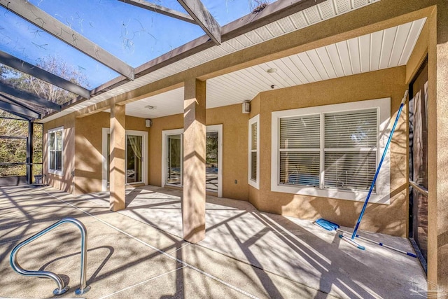 view of patio featuring a lanai