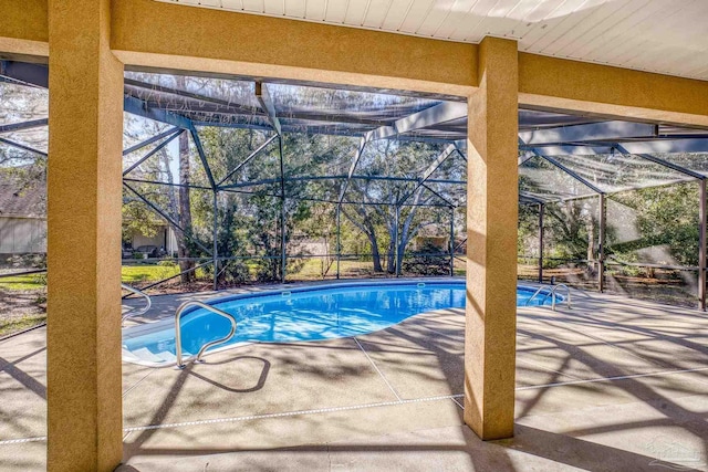 view of pool with a lanai and a patio area