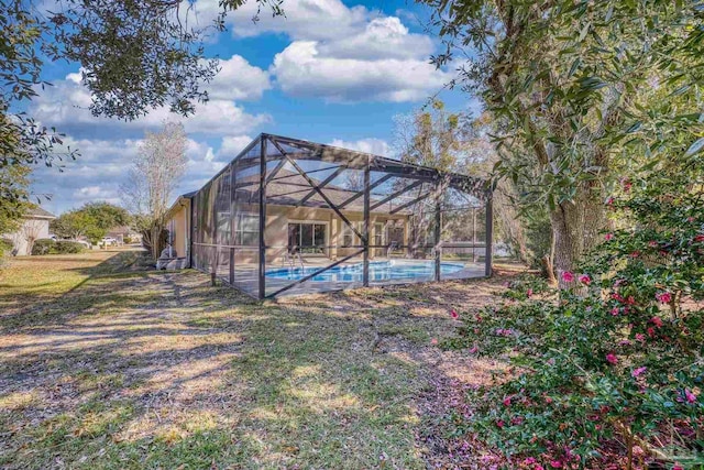 view of yard featuring glass enclosure