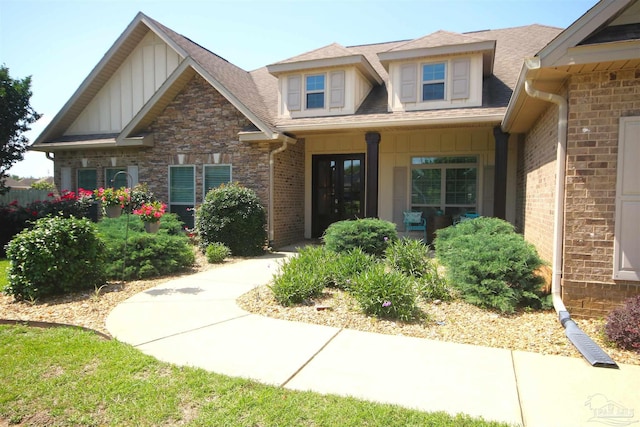 4125 Tamworth Ct, Pace, FL 32571 - view of front of property with board and batten siding, covered porch, brick siding, roof with shingles, and stone siding