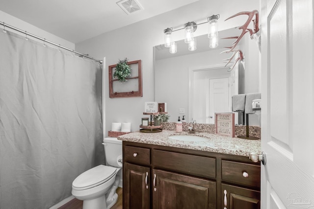 bathroom with visible vents, toilet, vanity, and a shower with shower curtain