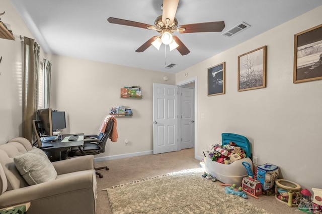 carpeted office space with a ceiling fan, baseboards, and visible vents